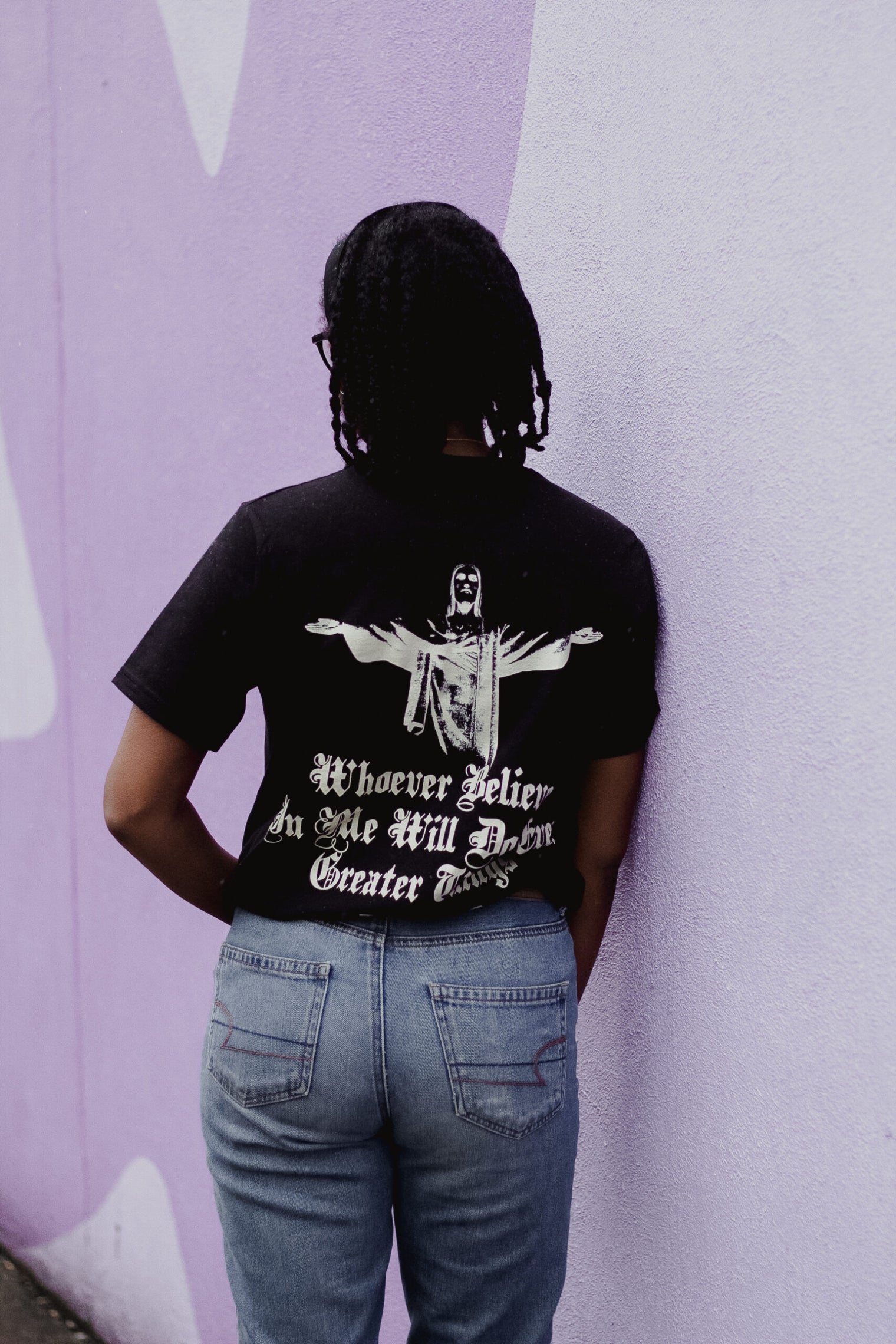 woman wearing greater things black tee back